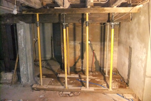 wooden beams embedded in walls support wooden beams